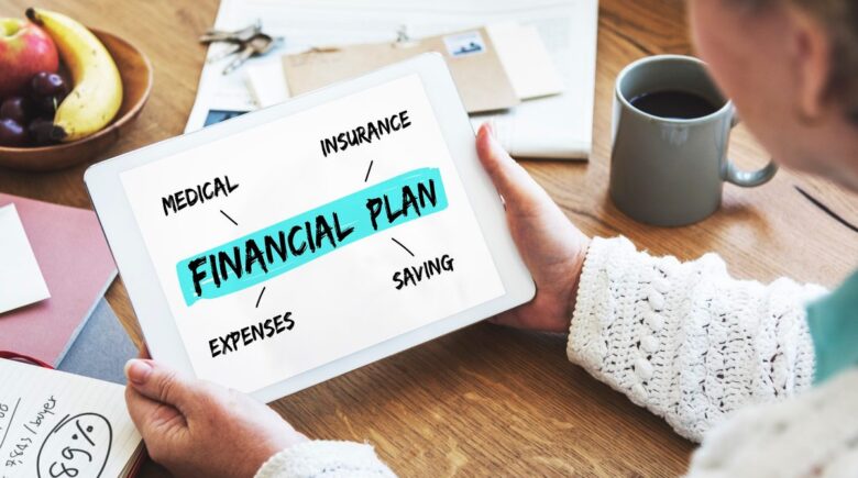 Person reviewing financial statements and bank statements on a desk for a personal financial audit