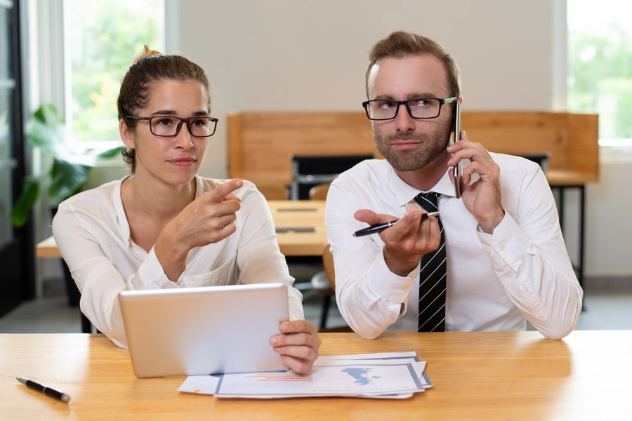 A worried employee reading a termination letter with a piggy bank and a 401(k) statement in focus