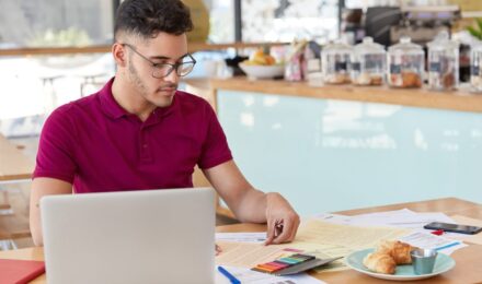 Small business owner analyzing expense forecasting data on laptop screen