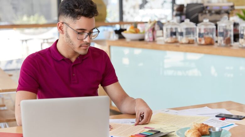 Small business owner analyzing expense forecasting data on laptop screen