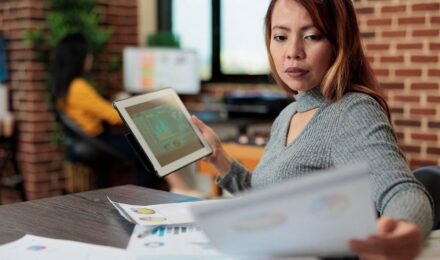 Comparison of AI expense tracker software interface versus traditional human accountant workspace