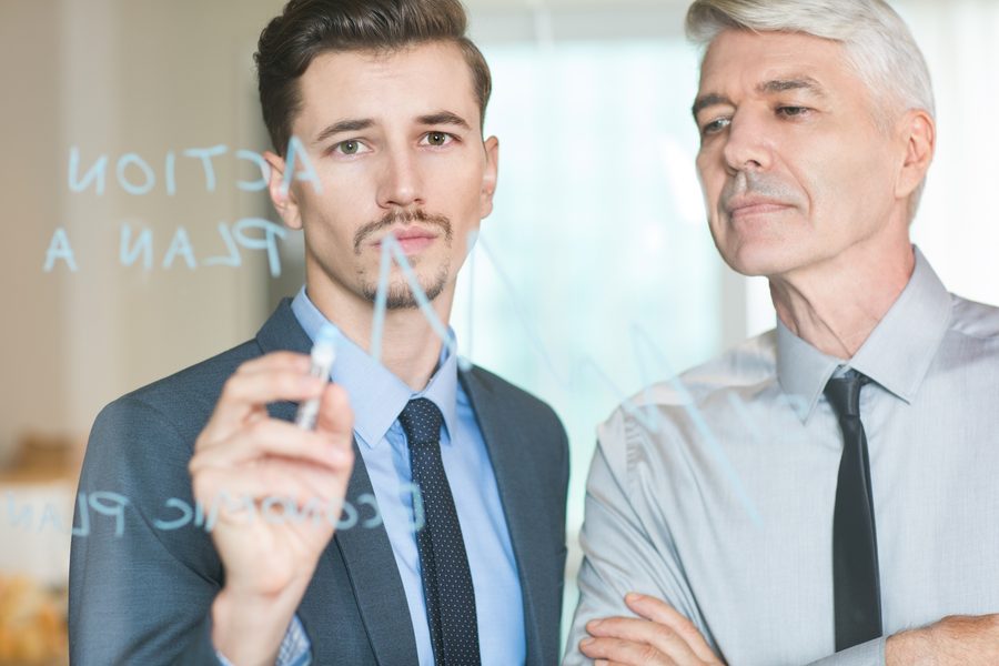 A human advisor and client reviewing a personalized financial plan