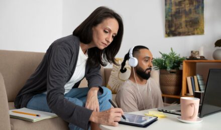Single parent using AI budgeting app on smartphone to manage household finances
