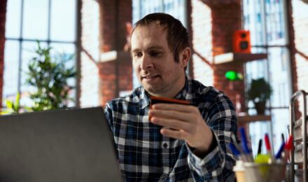 Iowa farmer reviewing payment settlement data on tablet connected to cloud-based AI payment routing system