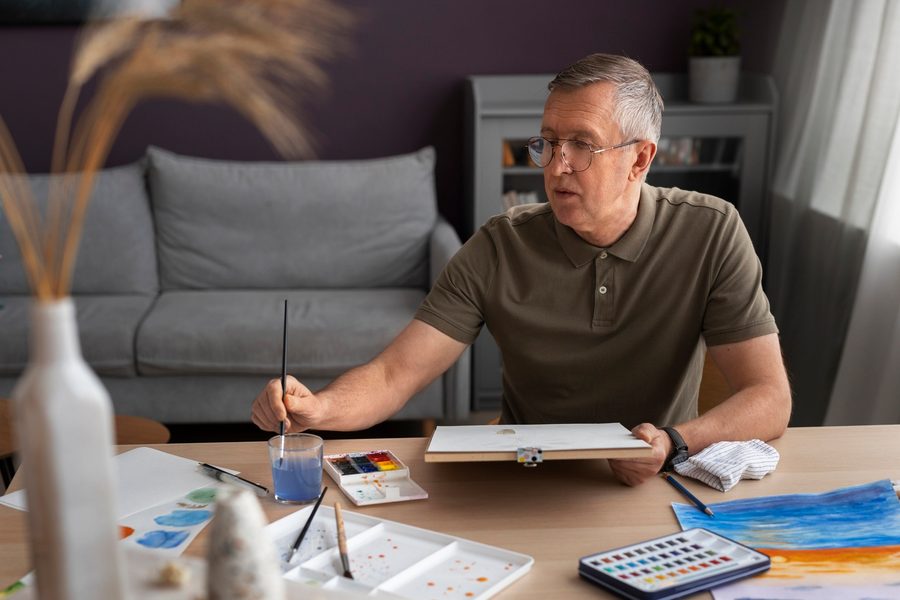 An older couple reviewing retirement projection charts on a laptop at their kitchen table.