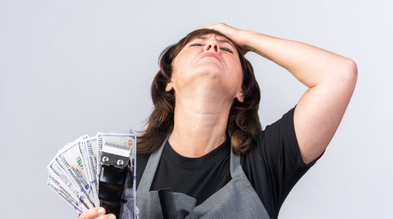 Person holding cash, considering financial decisions about a sudden money windfall