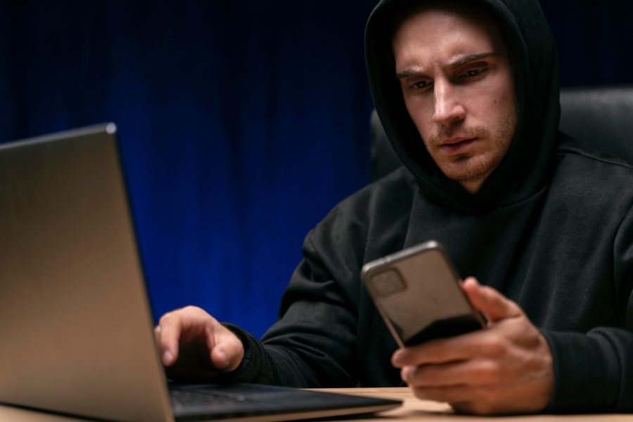 Smartphone showing fraudulent text message impersonating a digital wallet provider requesting login credentials