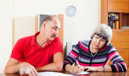 Same-sex couple reviewing retirement and Social Security benefits documents together
