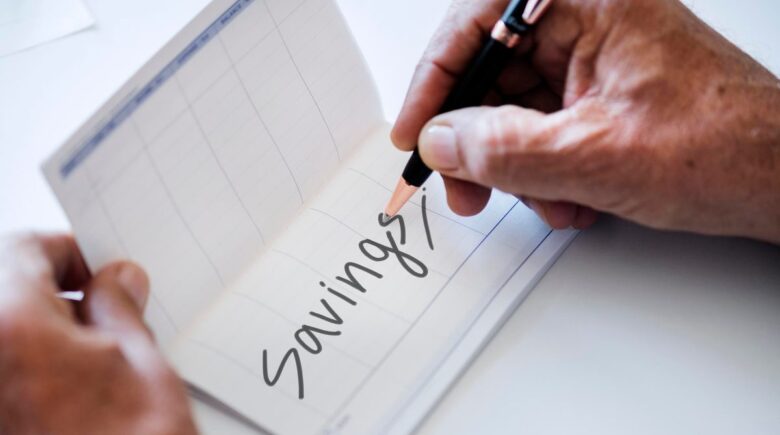Young adult setting up retirement investment on laptop with $200 monthly contribution plan