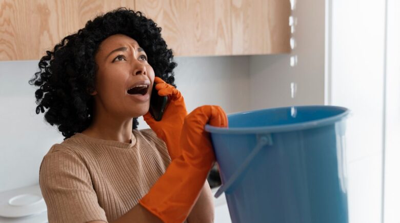Person looking at credit card bill and calculator, analyzing hidden spending leaks in monthly expenses